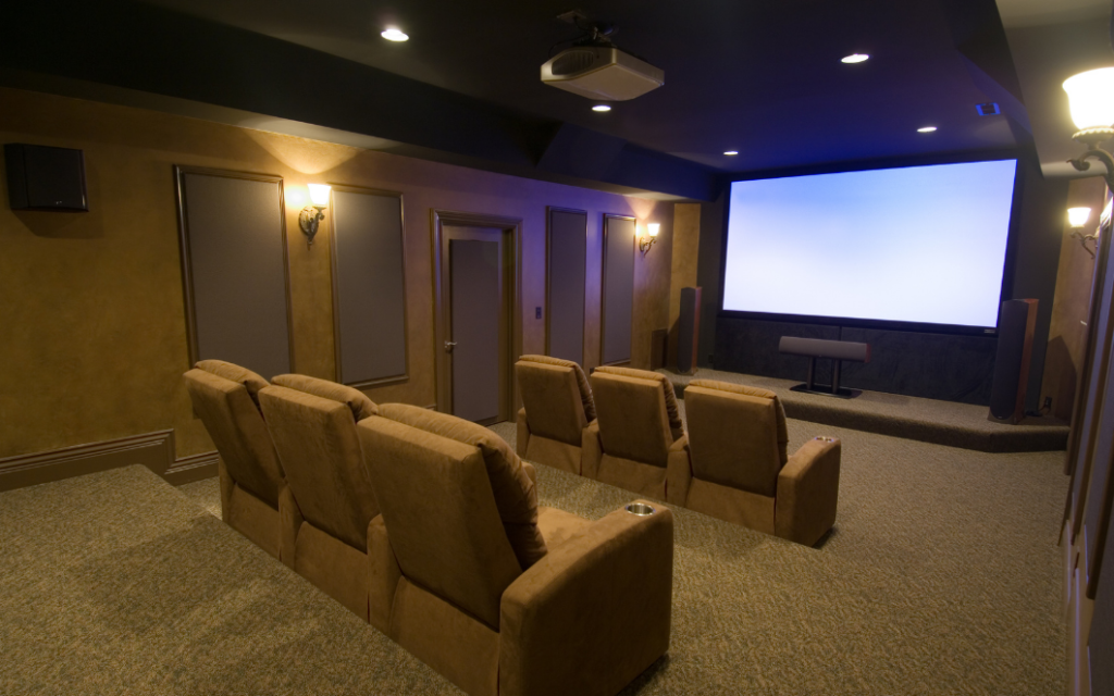 Contemporary media room with a large flat-screen television, comfortable seating, and integrated home entertainment system.