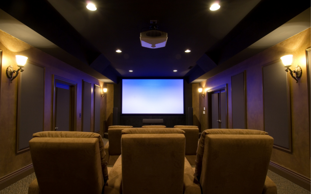 Contemporary media room with a large flat-screen television, comfortable seating, and integrated home entertainment system.