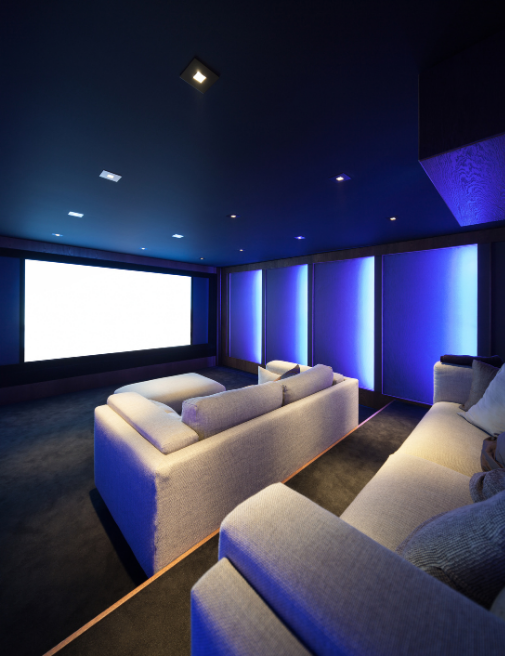 Modern home cinema installation with projector, Dolby Atmos speakers, and professionally designed entertainment space.