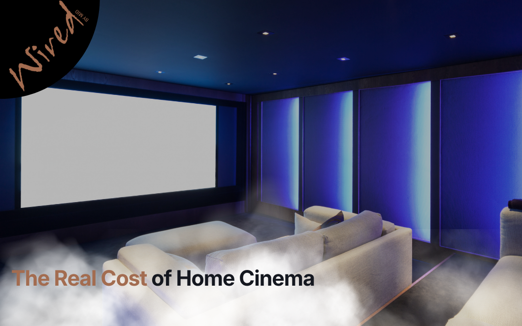 Premium home cinema room featuring a large projection screen, immersive surround sound system, ambient lighting, and luxury seating.