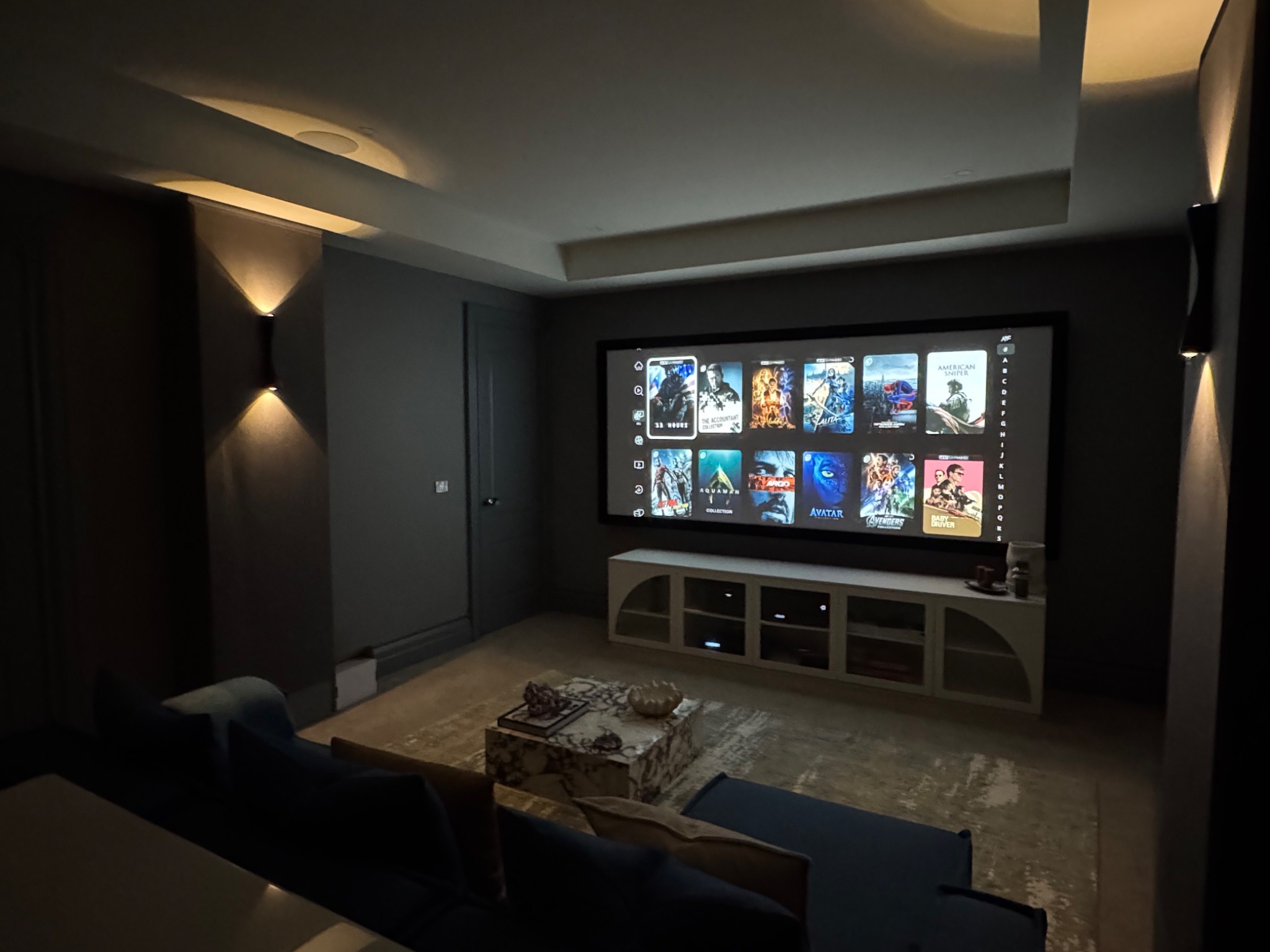 Dedicated home cinema room demonstrating premium audio, video, and acoustic design features