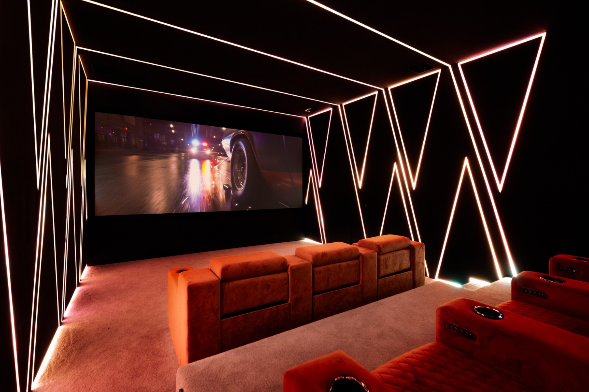 Custom-built home theatre showcasing high-end seating, lighting, and acoustic engineering